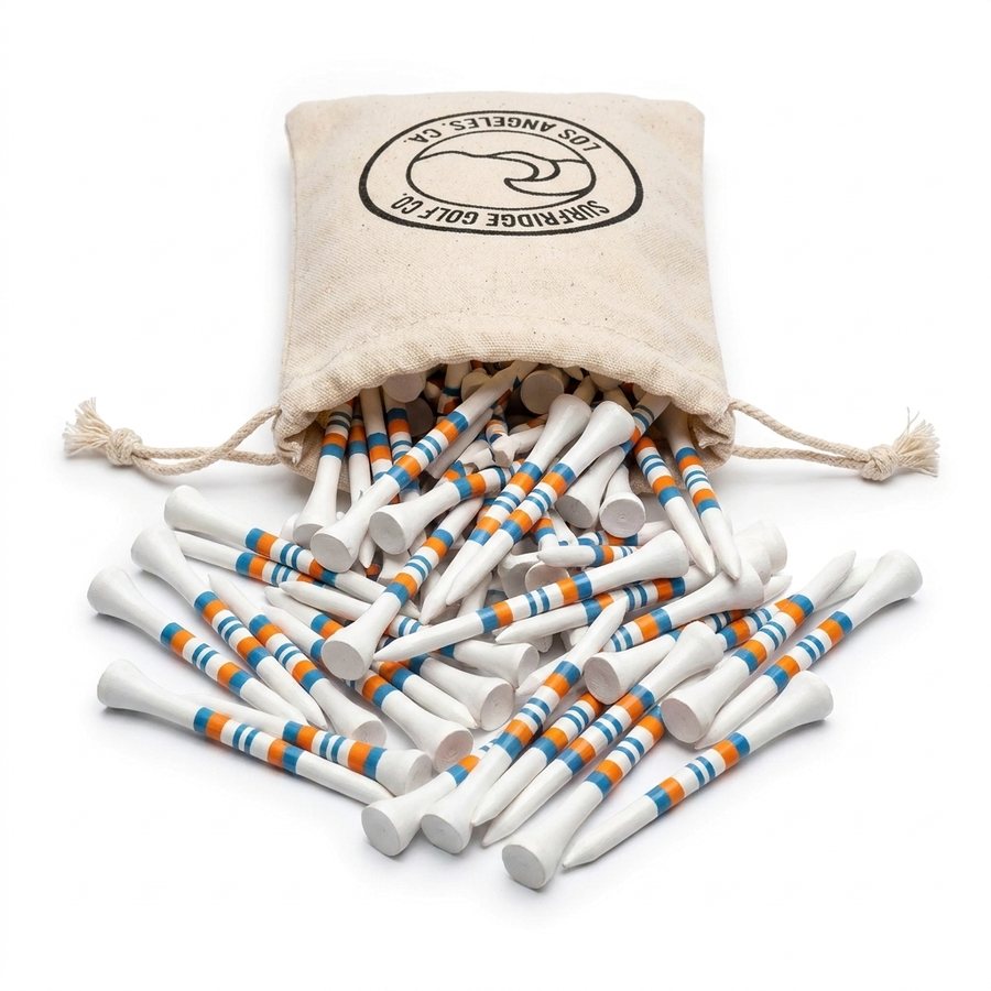 White bamboo golf tees with orange and blue stripes spilling from a Surfridge Golf Co. canvas drawstring bag